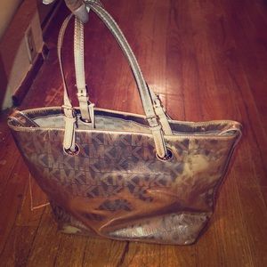 Pink metallic MK purse . Inside a little stained.